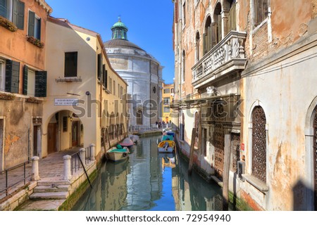 Old historic colorful houses along small canal in Venice, Italy.