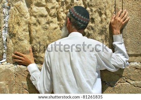 JERUSALEM - AUG 18: Unidentified person praying at Western Wall aka Wailing Wall during Tisha B\'Av fast day before major celebrations of Jewish New Year on August 18, 2004 in Jerusalem, Israel.