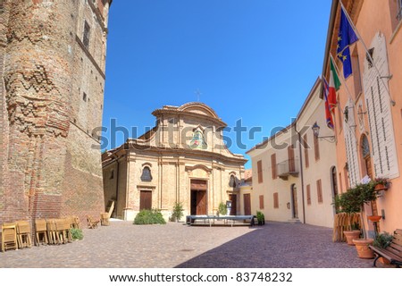 Central plaza with small church among city hall and ancient castle in Roddi - small town in Piedmont, northern Italy.