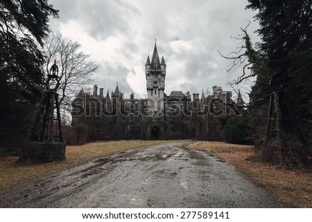 An old, abandoned and creepy castle on a dark and gray day in fall
