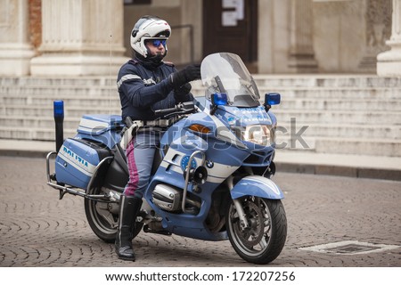 MANTUA, ITALY - JANUARY 8: representative of the road police on duty and his BMW-motorbike on the streets of Mantua, Italy on January 8, 2014.