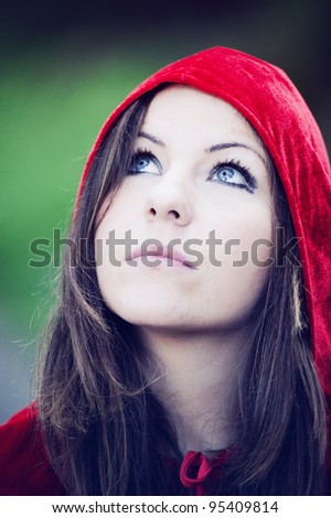 Girl with red hood and blue eyes watching sky