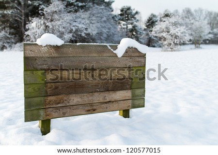 wood sign in snow landscape