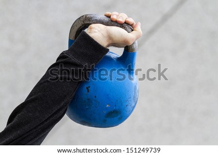 man holding a kettle bell used for crossfit