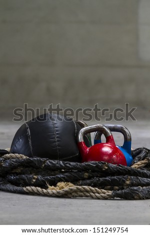 Kettle bells, rope and a medicine ball used for crossfit