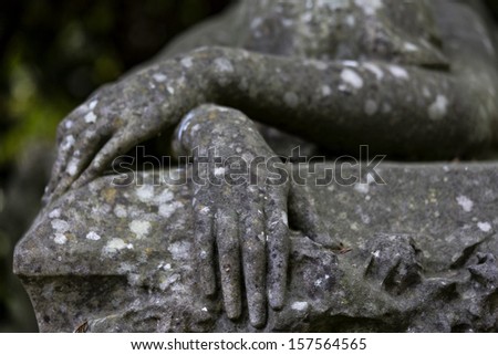 old stone statue hand in focus