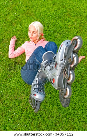 girl with rollers on the grass