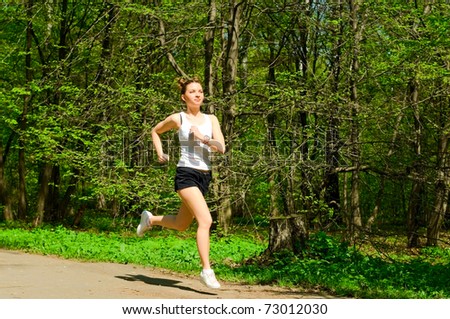 young woman running in park