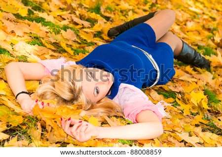 young woman resting on the maple leaves