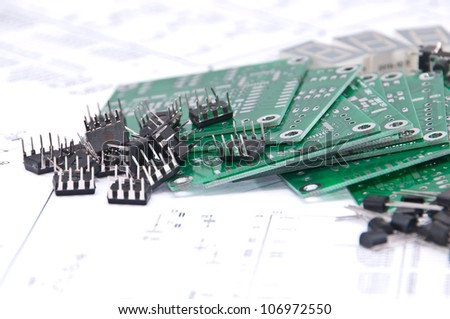 Circuit boards and electronic components with schematics in background