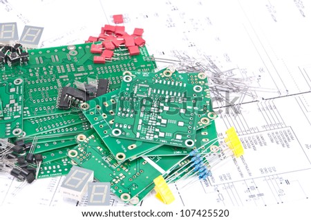 Group of electronic components with schematics in the background