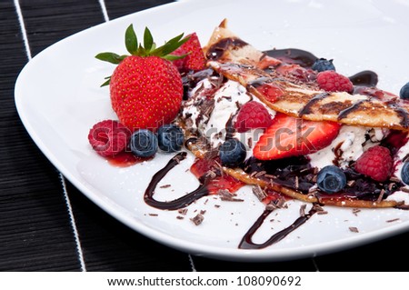 Ice in fresh Pan Cake with mixed fruits on black background