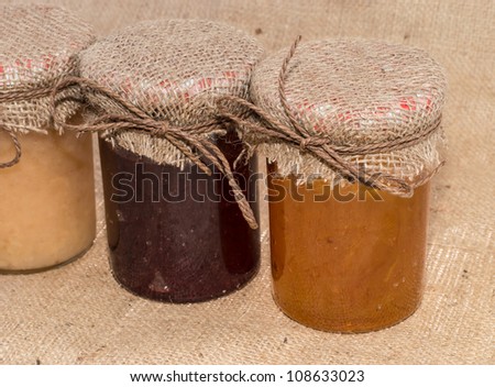 Fresh made Jam in jars on rustic background