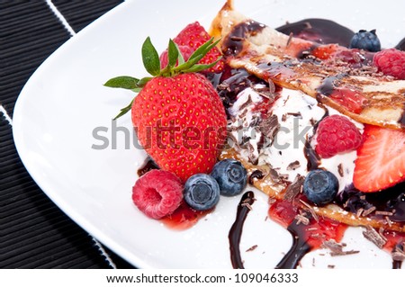 Ice in fresh Pan Cake with mixed fruits on black background
