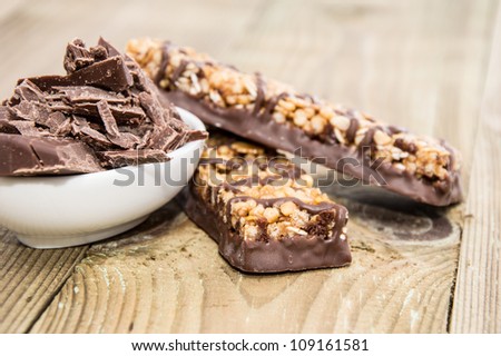Muesli Bars with Chocolate in a bowl on wooden background