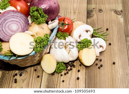 Different Vegetables in a basket on wooden background