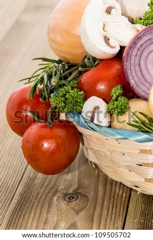 Many Vegetables in a basket on wooden background