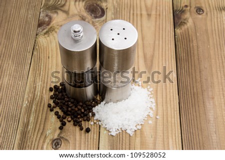 Salt and Pepper with shakers on wooden background