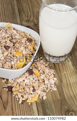 Mixed Muesli with a glass of Milk on wooden background
