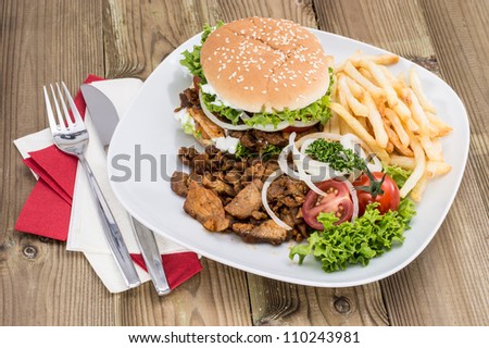 Fresh homemade Kebab Burger with Chips on wooden background