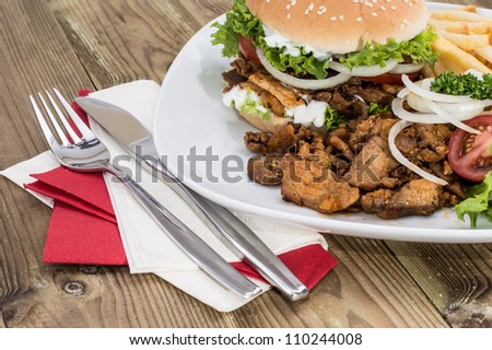 Kebab Burger with meat and Chips on wooden background