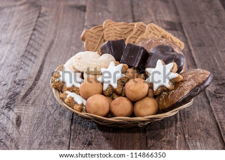 Basket with Christmas Sweets on wooden background