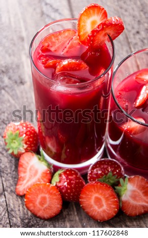 Strawberry Liqueur with fresh fruits on wooden background