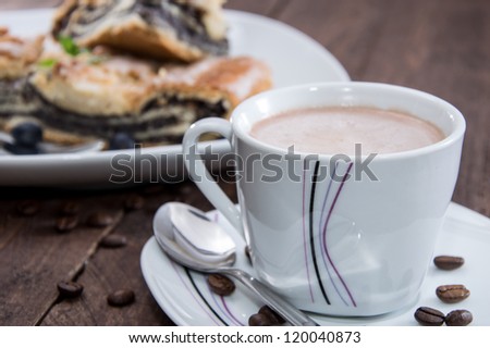 Poppy-Seed Cake with Coffee on wooden background