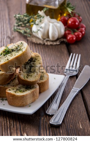 Portion of Garlic Bread on wooden background