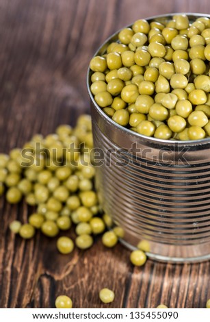 Canned Peas on vintage wooden background