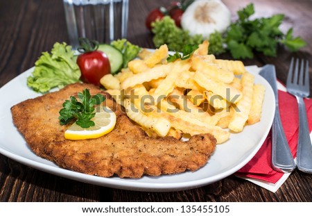 Portion of Schnitzel with Chips on a plate