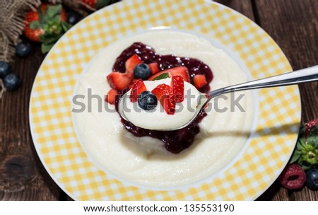 Plate with Semolina Pudding. Topped with fresh mixed berries