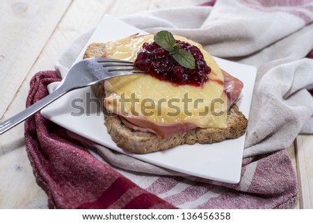 Fresh made portion of Toast Hawaii with cranberrie sauce