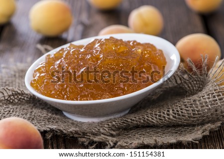 Portion of Apricot Jam on rustic wooden background
