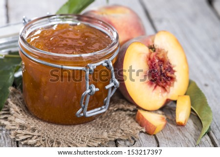 Homemade Peach Jam on wooden background