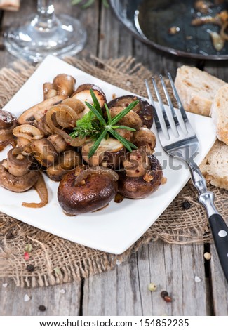 Fried Mushrooms with herbs and onions on a plate