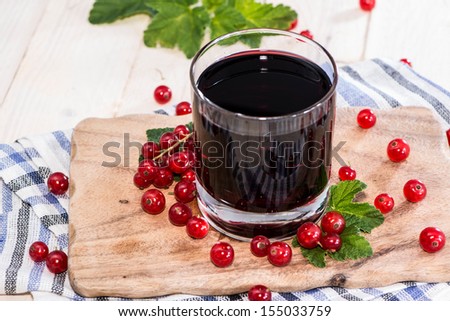 Red Currant Juice on wooden background