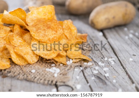 Heap of Paprika Potato Chips on rustic background