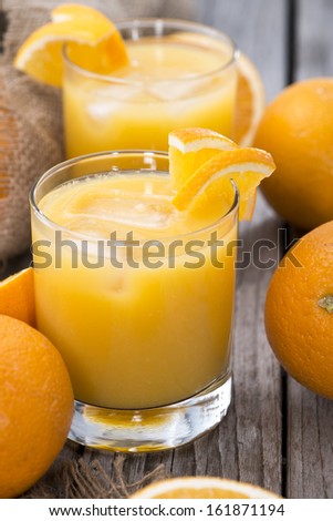 Fresh made Orange Juice on wooden background