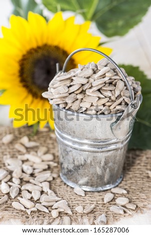 Portion of fresh Sunflower Seeds on wooden background