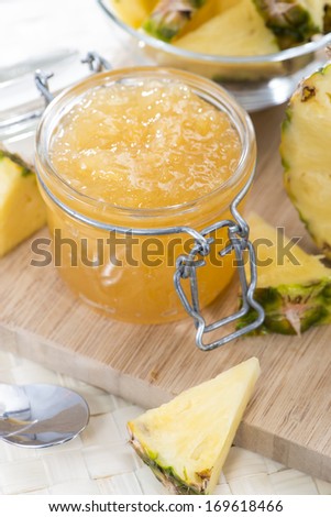 Homemade Pineapple Jam in a small glass with fresh fruit pieces