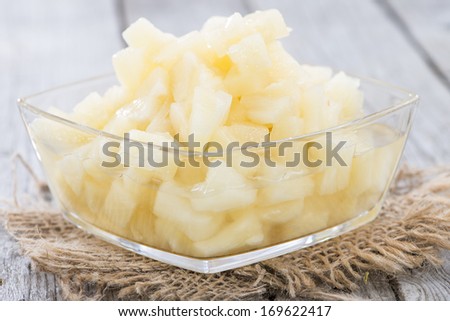 Canned Pineapple on vintage wooden background (close-up shot)