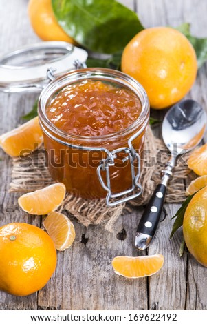 Fresh homemade Tangerine Jam on wooden background