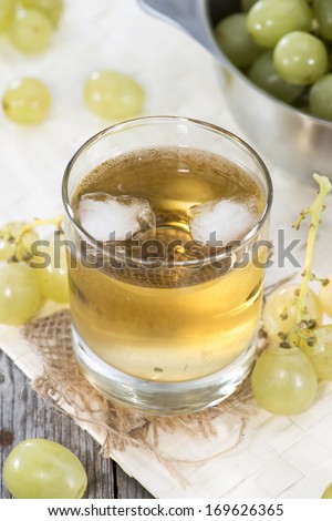 Fresh made Grape Juice with fresh fruits in a glass