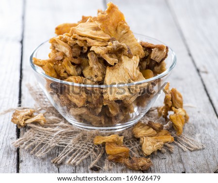 Dried Pineapple on wooden background (close-up shot)