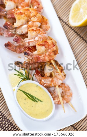Portion of skewered Prawns with fresh made Curry Sauce