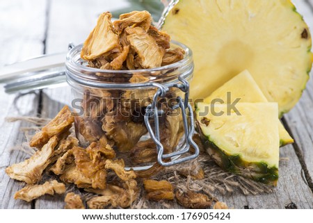 Portion of dried Pineapple (close-up shot with some fresh fruits)