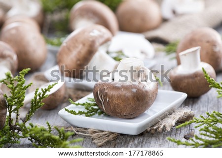 Fresh Mushrooms on vintage wooden background