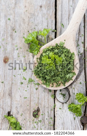 Portion of dried Parsley on a wooden spoon