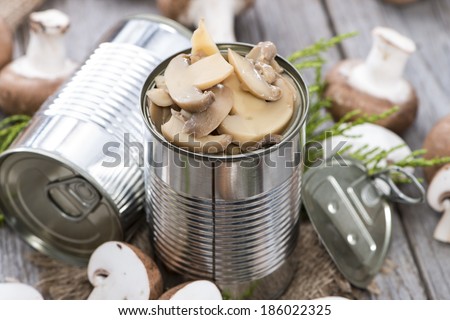 Portion of Canned Mushrooms on wooden background
